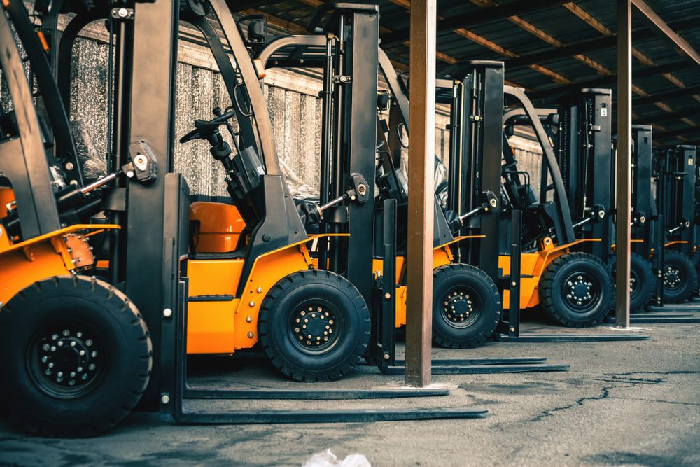 A row of forklifts waiting for forklift maintenance services