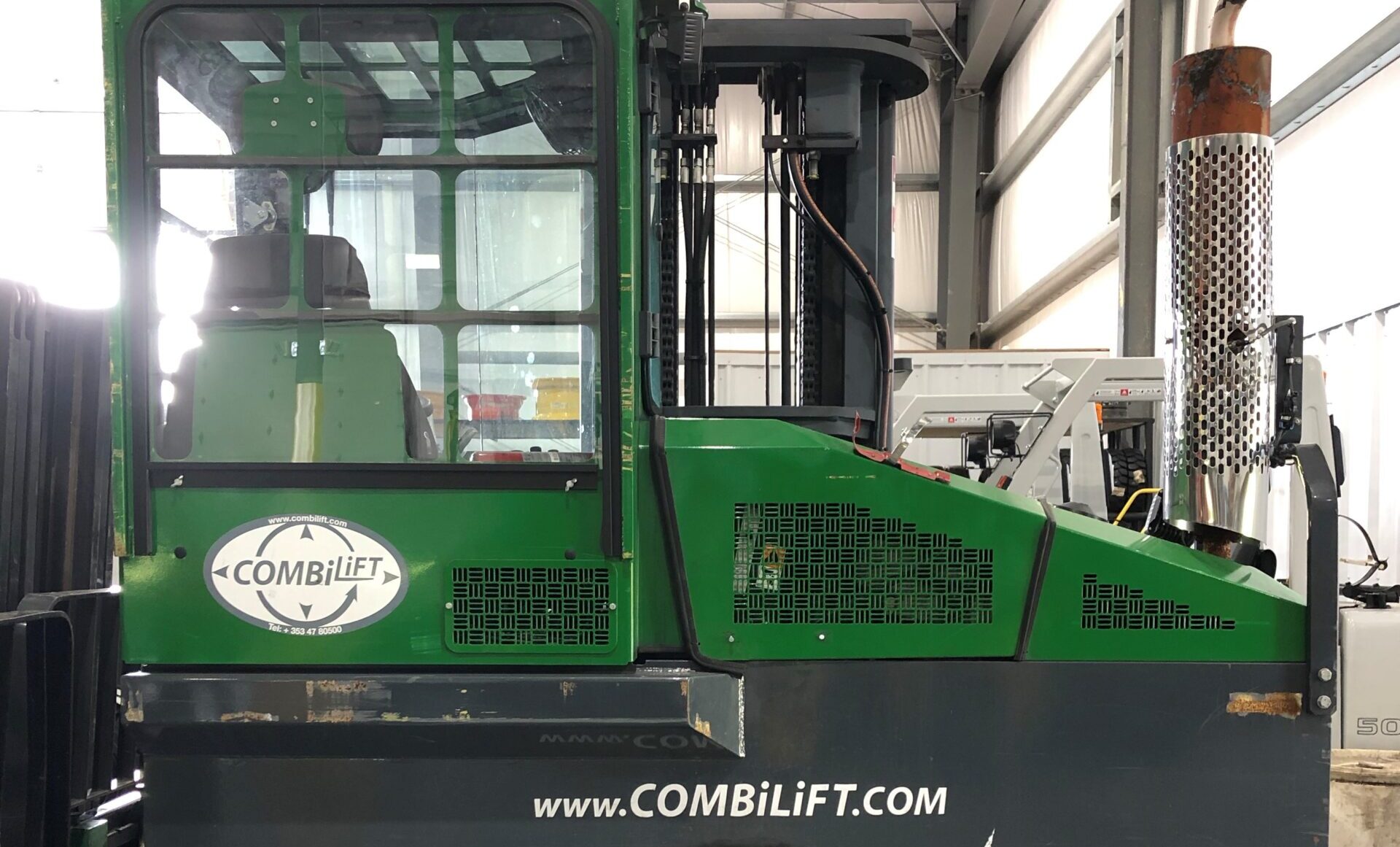 A green and black combilift in a warehouse